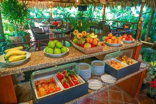 a buffet line with fruits and vegetables in bowls at Jardin del Eden Boutique Hotel in Tamarindo