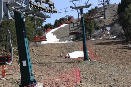 a person is standing on a ski lift at Isminis Petroktisto Holidays Stonehouse in Palechori