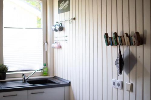 a kitchen with a sink and a counter and a window at Hideaway Extertal in Extertal