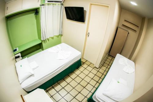 Postel nebo postele na pokoji v ubytování Cidade Verde Flat Hotel