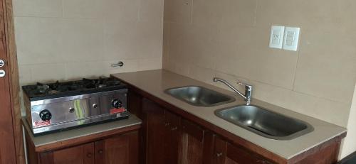 a kitchen with two sinks and a stove at SHOTEL Calafate in El Calafate