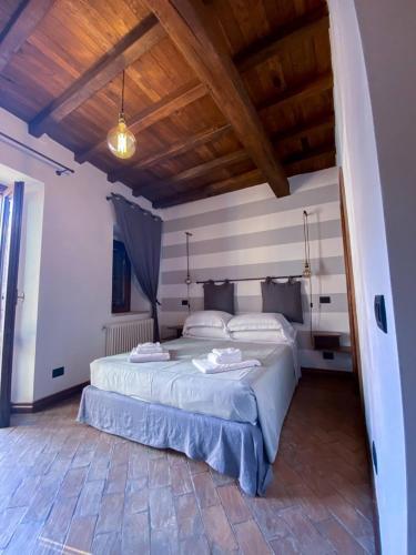 a bedroom with two beds and a wooden ceiling at Al Palazzetto in Tivoli