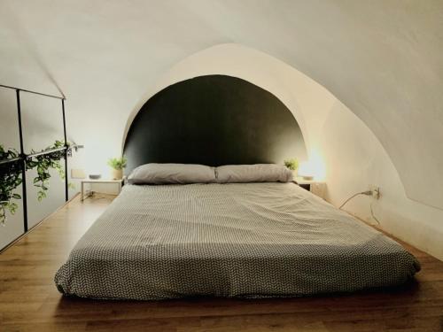 een slaapkamer met een groot bed in een witte kamer bij STUDIO LOFT in the CENTER SANREMO FOR 3 PEOPLE in Sanremo