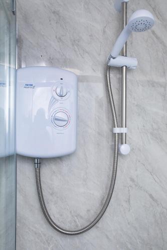 a shower in a bathroom with a shower at Burford Lodge Guest House in Ardglass