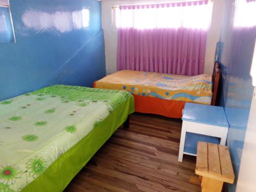 Postel nebo postele na pokoji v ubytování Hostal Yumbo Imperial