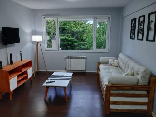 a living room with a couch and a table at Departamento Centrico en Bariloche IIæ in San Carlos de Bariloche