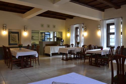 a dining room with tables and chairs in a restaurant at Horský hotel Anděl in Andělská Hora