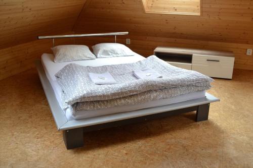 a bedroom with a bed with two pillows on it at Horský hotel Anděl in Andělská Hora