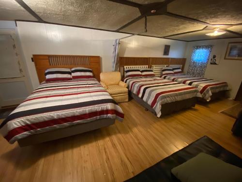 um grupo de quatro camas num quarto em VA Beach Zen retreat house em Virginia Beach