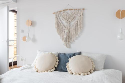 a bedroom with a white bed with two pillows at Zatoka Relaksu Mechelinki in Mechelinki