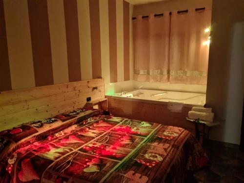 a bathroom with a bed and a bath tub at Hotel Sirio in Boscotrecase