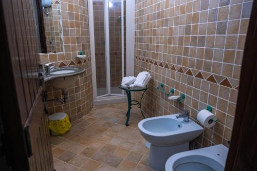 a small bathroom with a toilet and a sink at Hotel Sirio in Boscotrecase