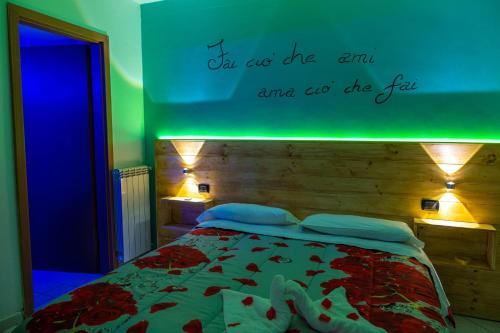 a bedroom with a bed with the words on the wall at Hotel Sirio in Boscotrecase