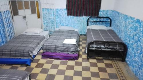Ένα ή περισσότερα κρεβάτια σε δωμάτιο στο Hostal Azul Puebla