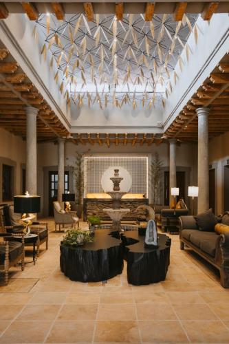 a large living room with a large ceiling at Dos Patios Querétaro Curamoria Collection in Querétaro