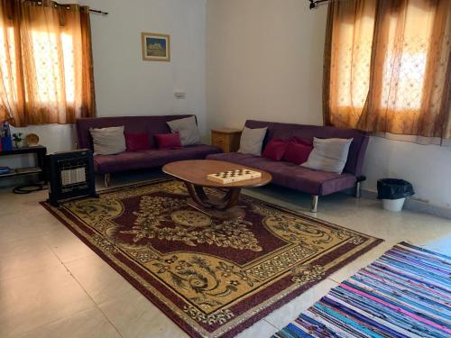 a living room with a couch and a table at Khan Alsira - חאן אלסרה in Alsira