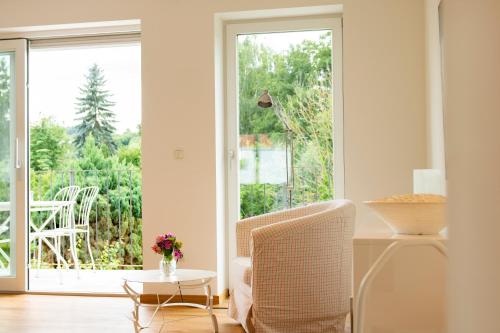 a living room with a chair and a window at Ferienwohnung auf ehemaligen Bauernhof in der Nähe von Bamberg in Walsdorf
