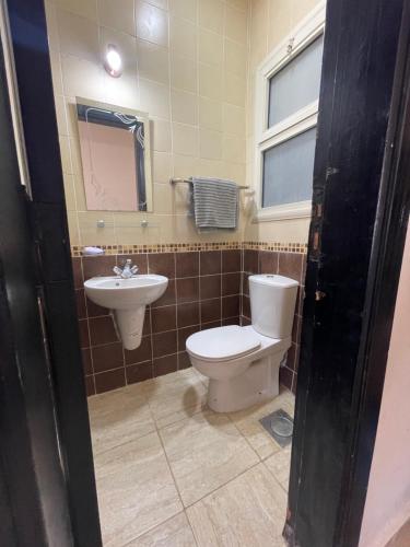 a bathroom with a toilet and a sink at Yahia Blumar North Coast in El Alamein