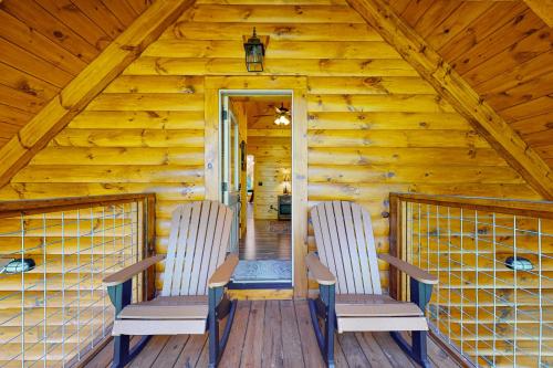 two chairs sitting on the deck of a cabin at Knotty Escape in Gatlinburg