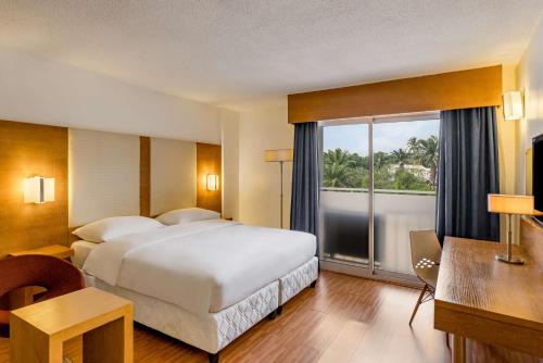 a hotel room with a bed and a large window at Park Inn by Radisson Abeokuta in Abeokuta