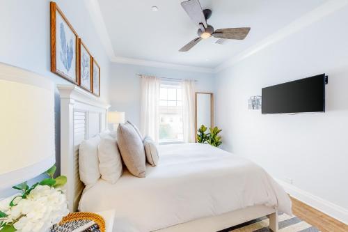 a white bedroom with a bed and a ceiling fan at BrightWater Blue 158-2 in Clearwater Beach