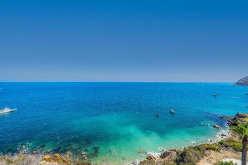 an aerial view of the ocean with people in the water at Gorgeous Oceanfront Villa With Panoramic Views in Avalon