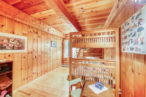 a cabin with a spiral staircase in a room with wooden walls at Log Cabin with a View in Andover