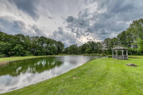 a gazebo sitting on the side of a lake at Log Cabin with a View in Andover