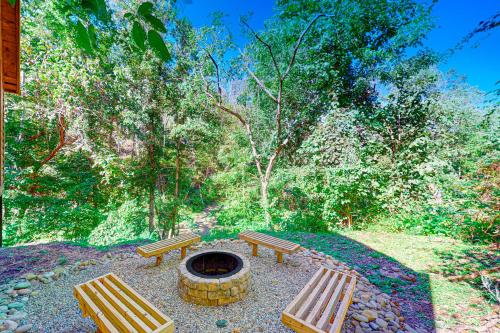 two benches and a fire pit in a park at Knotty Escape in Gatlinburg