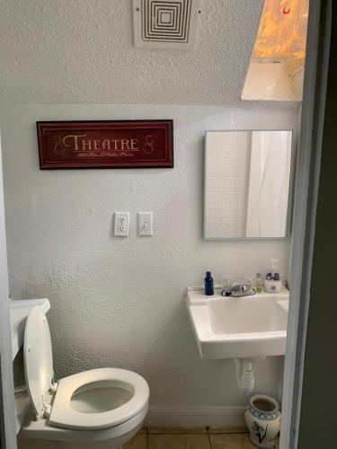 a bathroom with a white toilet and a sink at Va Beach Zen tree house style studio F in Virginia Beach