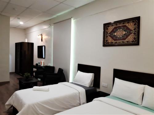 Tempat tidur dalam kamar di Blue Eyes Hotel