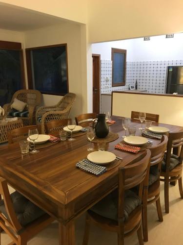 a dining room with a wooden table and chairs at Bukit Indah Boutique Accommodation in Selong Belanak