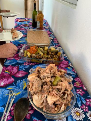a table with a plate of food on a table at Pousadinha da Lulu - Pontal Mangue Seco in Indiaroba