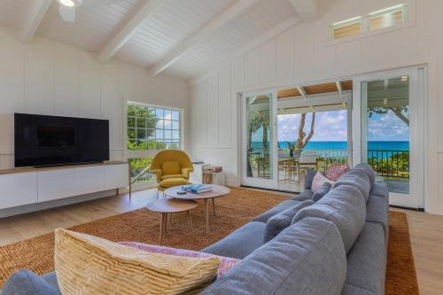 a living room with a couch and a tv at Camp Alealea 2 home in Hanalei