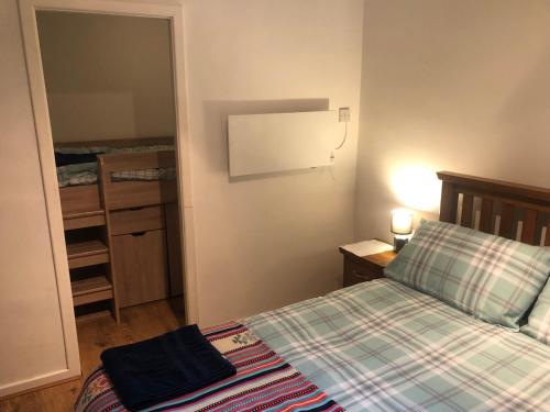 a small bedroom with a bed and a mirror at Central Lisburn Duplex Apartment No Parties in Lisburn