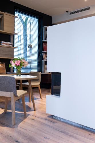 a living room with a table and a fireplace at Hotel Max in Paris