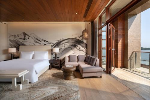 a hotel room with a bed and a chair at Yanqi Hotel, Managed by Kempinski in Huairou