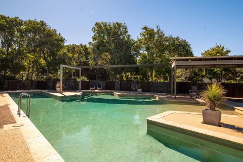 a swimming pool in a yard with at The Sebel Twin Waters in Twin Waters
