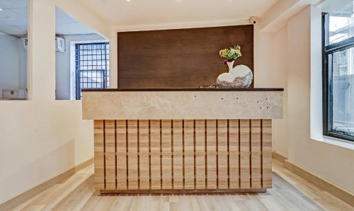 a lobby with a counter with a vase on it at Itsy Hotels Classio Richmond in Bengaluru