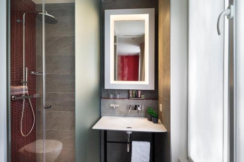 a bathroom with a sink and a shower at Hotel Max in Paris