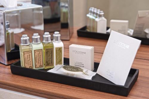 a display of bottles of perfume on a table at Fraser Place Canary Wharf in London