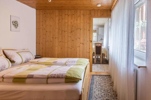 a bedroom with two beds and a window at Ferienwohnung Grauer in Moos