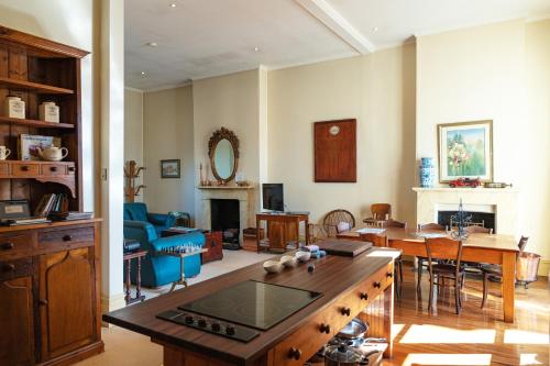 a living room with a table and a dining room at Fire Station Inn in Adelaide