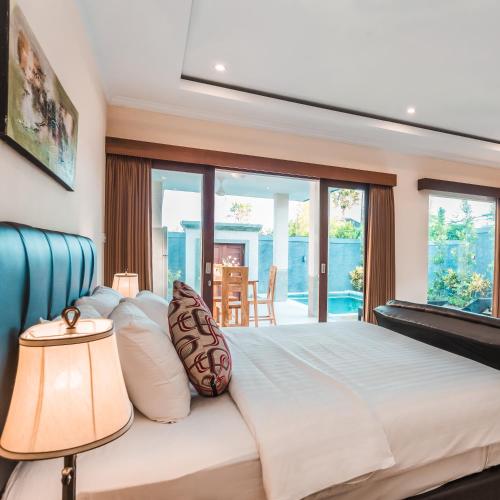 a bedroom with a bed with a view of the ocean at Kubu Petitenget Suite Seminyak in Seminyak