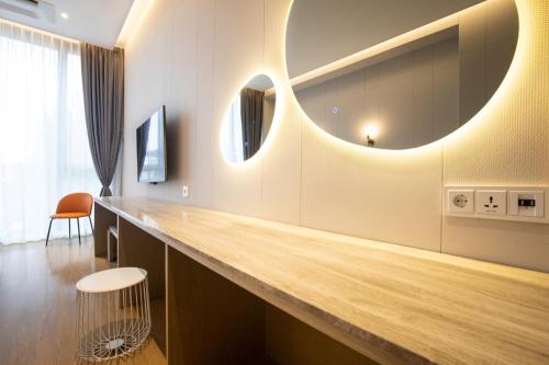 a room with a counter with a large mirror at Jeonju Tourist Hotel kkotsim in Jeonju
