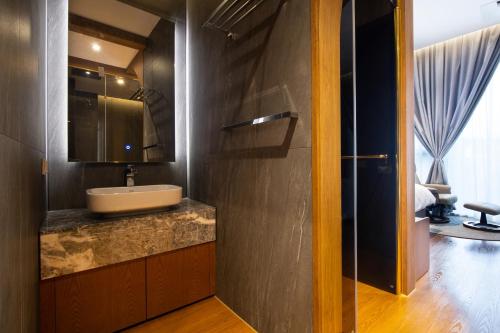 a bathroom with a sink and a mirror at Jeonju Tourist Hotel kkotsim in Jeonju
