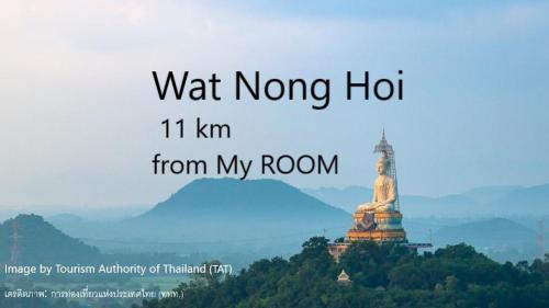 a sign that reads wait nong ho km from my room with a statue at My Room in Ratchaburi