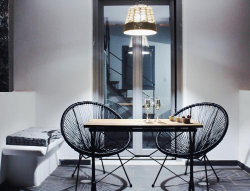 a dining room with a table and two chairs at Aeron Suites in Éxo Goniá