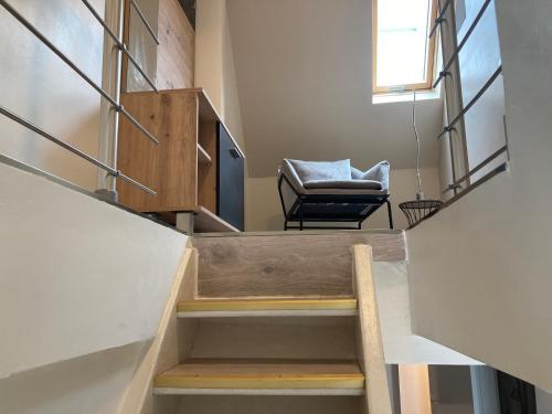 a room with a staircase with a chair and a window at Ferienhaus "LE RUISSEAU" in Badenweiler