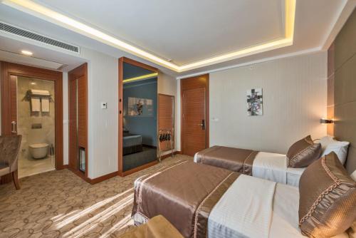 Habitación de hotel con 2 camas y baño en Glorious Hotel, en Estambul